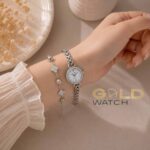 ست ساعت زنانه نقره‌ای نگین‌دار به همراه دستبند طرح گل